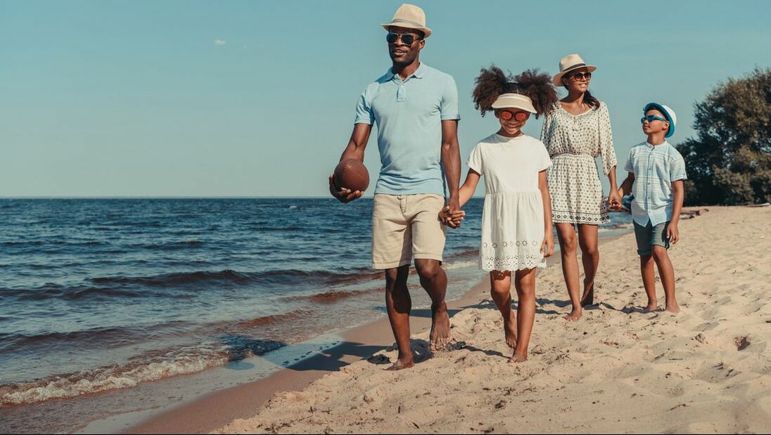 family walking on beach together